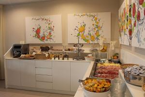 a kitchen with a counter with food on it at Hotel Miramare in Caorle