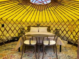 a table and two chairs in a yurt at Whitetail Creek Camping Resort in Lead