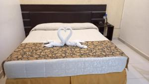 Rúm í herbergi á SBS Hotel & Spa