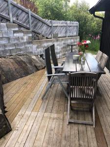 einen Holztisch und Stühle auf einer Holzterrasse in der Unterkunft Ramsbu Hovden Fjellpark sen utsjekk in Hovden