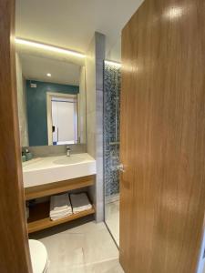 a bathroom with a sink and a toilet and a mirror at GoConcept Studio Sardegna in Olbia +23 photos