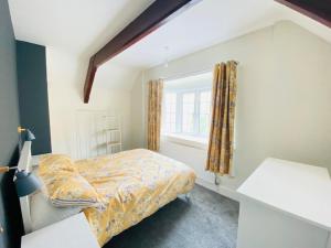 a small bedroom with a bed and a window at Ravelstone in Church Stretton