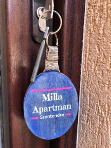 a blue tag on a door with the text milka apartmentarianerate at Milla Apartman in Szentendre