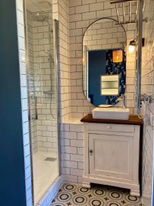 a bathroom with a shower and a sink and a mirror at Logis « Henriette » • Maison du XVe siècle in Provins