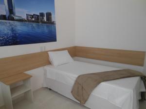 En eller flere senger på et rom på Pousada Dubai
