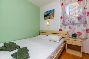 a small bedroom with a bed and a window at Al Mare Apartments in Rovinj