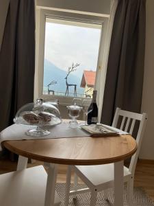 a dining room table with a view of a window at B&B L'edera in Trento