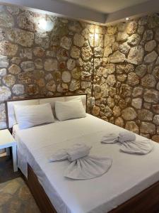 a bedroom with a bed with two towels on it at CHRISTIES LUXURY SUITES in Syvota