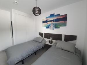 Łóżko lub łóżka w pokoju w obiekcie Bayview Hills - Balcón del Mediterráneo