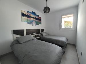 Łóżko lub łóżka w pokoju w obiekcie Bayview Hills - Balcón del Mediterráneo