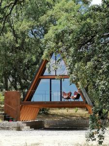 a house with two chairs in a tree at Carvalhal Redondo - Farm House in Castelo Novo