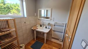 a bathroom with a sink and a mirror at Ô de mer - à 20m de la plage in Sangatte