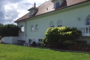 a white building with a clock tower on top of it at Appartement -Villa ROYAL Hélène in Oberlauterbach +28 photos