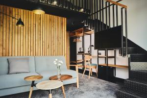 a living room with a couch and a table at New Port Apartments on the River in Krakow