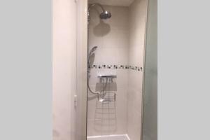 a shower with a glass door in a bathroom at LOVE ROOM OUT OF TIME *JACUZZI* in Itteville