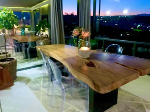 a wooden table and chairs in a room with a window at Best View @ No 2 in Plettenberg Bay