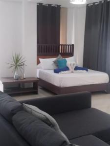 a living room with two beds and a couch at private apartment estudio ocean view solo adultos in La Laguna