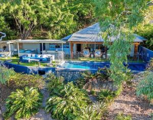 an aerial view of a house with a swimming pool at Beachfront Peace Cabin in Oak Beach