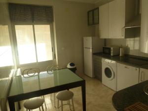 a kitchen with a table and some chairs in it at Alojamiento VuT Rupurupay A in Aldeadávila de la Ribera