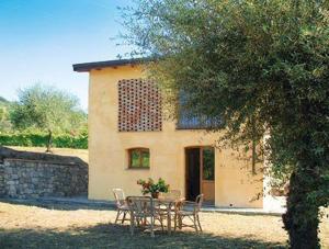 a table and chairs in front of a house at Agriturismo La Villa in Bolano