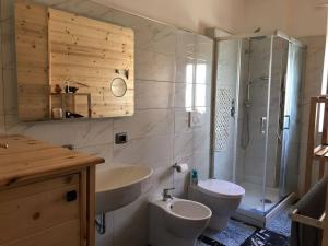 a bathroom with a toilet and a sink and a shower at Light Home in Avellino +21 photos