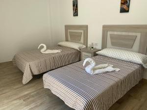 Llit o llits en una habitació de La Casita Alere en Playa Carnota con patio y barbacoa
