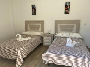Llit o llits en una habitació de La Casita Alere en Playa Carnota con patio y barbacoa
