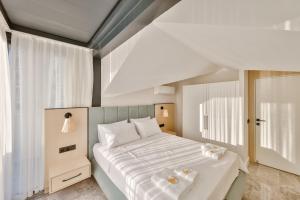 a bedroom with a large bed with white sheets at Sole Suites in Kas