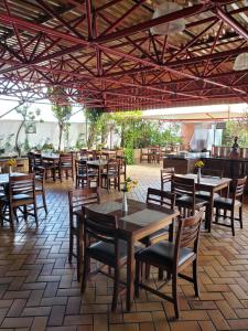 a restaurant with wooden tables and chairs and a patio at Vitória Marina in Salvador
