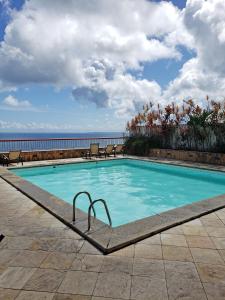 a swimming pool with a view of the ocean at Vitória Marina in Salvador +8 photos