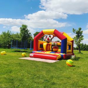 a playground with a inflatable bounce house in a field at Dworek Rutkowskich in Borowskie Cibory