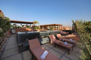 um pátio no último piso com sofás e uma piscina em Riad L'Etoile D'Orient em Marrakech