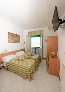 Postel nebo postele na pokoji v ubytování Hotel Rex