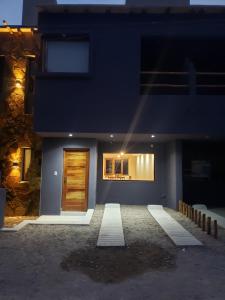 a blue house with a door in the night at Lo del Chango in Purmamarca