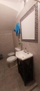 a bathroom with a sink and a toilet and a mirror at Lo del Chango in Purmamarca +4 photos