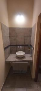 a bathroom with a sink and a light on the wall at Lo del Chango in Purmamarca