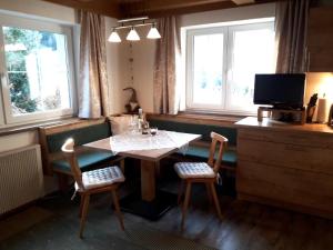 uma sala de jantar com uma mesa e duas cadeiras em Petter 1 em Tobadill