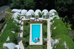 an aerial view of a house with a swimming pool at Igloo Beach Lodge in Manuel Antonio