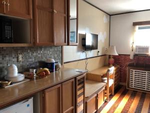 a kitchen with wooden cabinets and a counter top at Heritage Place Hotel in Gravelbourg