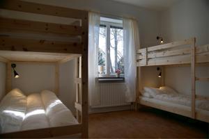 two bunk beds in a room with a window at Virserum Hostel in Virserum