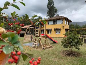 a house with a playground in front of it at CASA CAMPESTRE VILLA SANTANA in Villa de Leyva