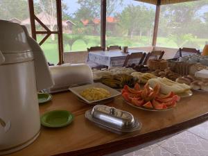 a wooden table with a buffet of food on it at Alta Vista Amazon Lodge in Manacapuru +121 photos