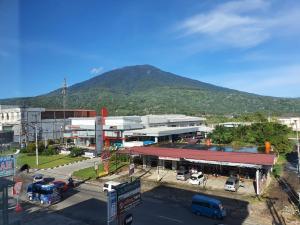 a view of a city with a mountain in the background at Muara Hotel Bukittinggi in Padangluar