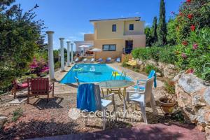 an image of a villa with a swimming pool at Wonderful quiet area,Complete Privacy,Large Pool, Colorful Garden, jacuzzi/Sauna in Peyia