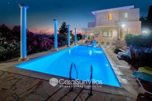 une grande piscine bleue en face d'une maison dans l'établissement Wonderful quiet area,Complete Privacy,Large Pool, Colorful Garden, jacuzzi/Sauna, à Peyia