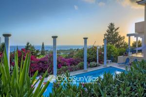 a villa with a swimming pool and flowers at Wonderful quiet area,Complete Privacy,Large Pool, Colorful Garden, jacuzzi/Sauna in Peyia
