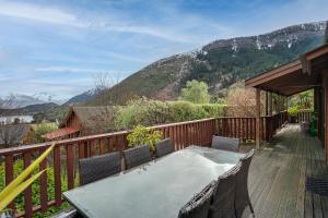 a patio with a table and chairs on a deck at Alpine Hide Away - 2 bedroom in Closeburn