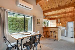 a kitchen and dining room with a table and chairs at Alpine Hide Away - 2 bedroom in Closeburn