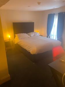 a bedroom with a large bed and a window at The Star Inn in Ringwood