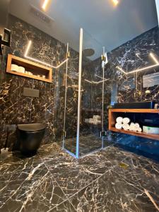 a bathroom with a black marble wall at Golan Hotel in Tiberias